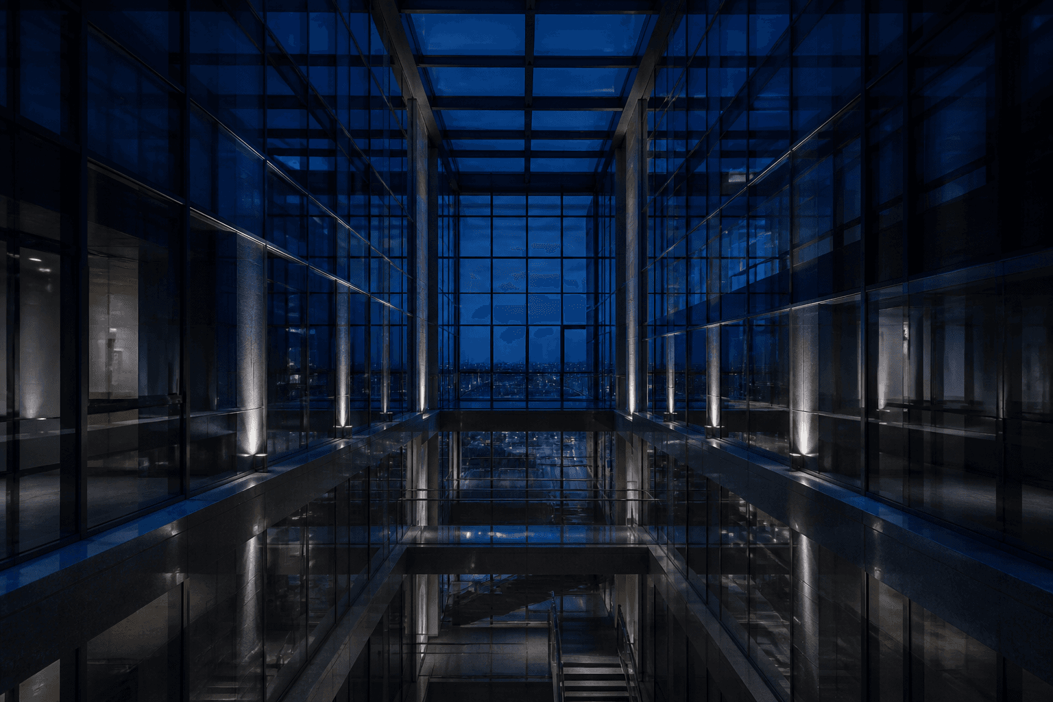 Quiet glass atrium at blue hour